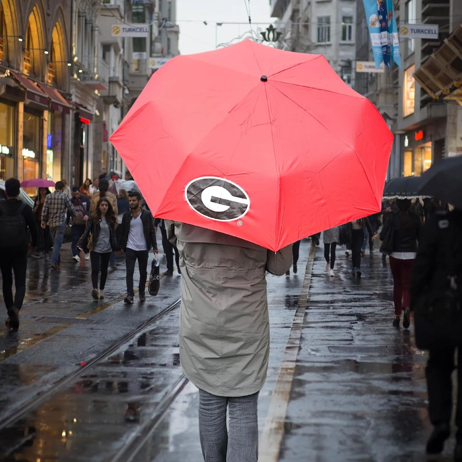 Mini Compact Storm Umbrella - NCAA Logo 42” Coverage, Folds to 11 Inches- Swivel Clip on Handle - Water, Wind & Rust Resistant, and Flexible Frame